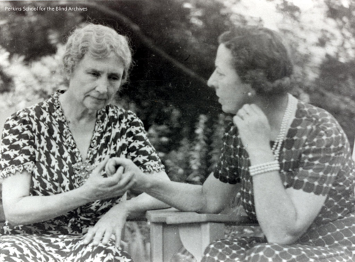 Black and white image of Helen Keller (left) communicating with Polly Thomson - circa 1940