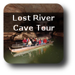 Picture of a boat on a river in a cave.