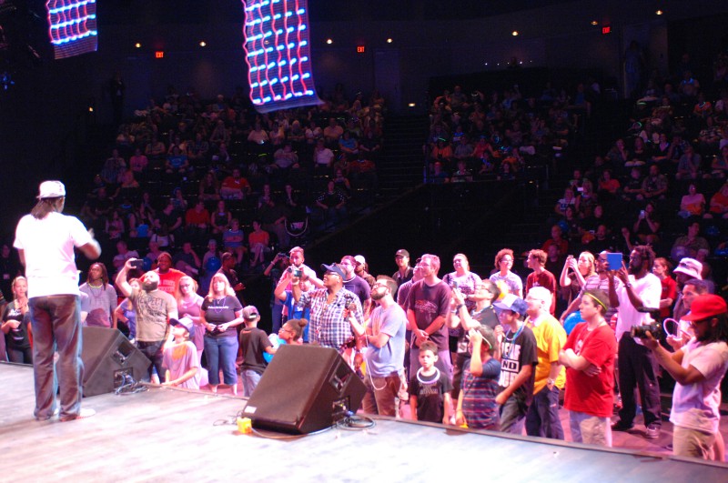 Performer on stage in front of an audience.