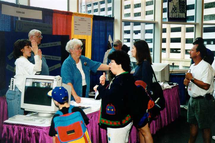 Several people attending the KCDHH Information Booth