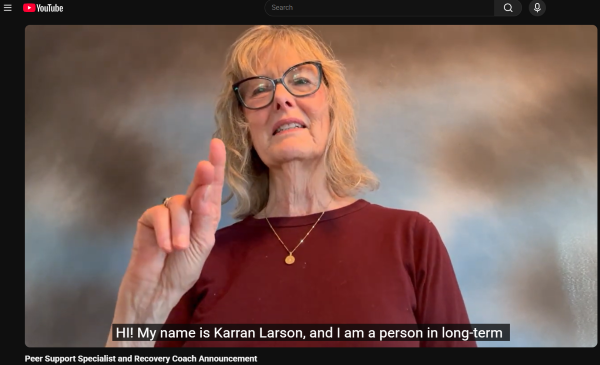 Video screenshot of Karran Larson signing.